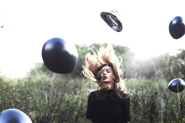 image of a girl surrounded by balloons