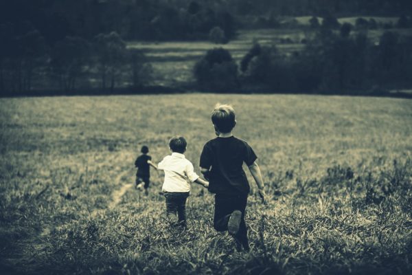 Kids running in a field image for utopia