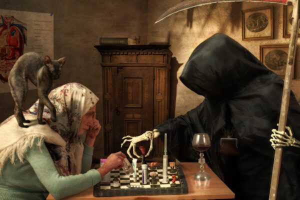 grim reaper playing chess with a woman